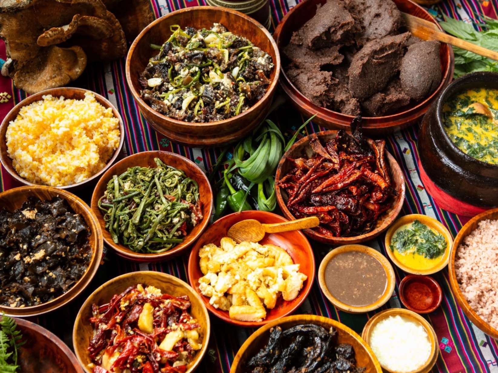 Bhutanese dishes including ema datshi and red rice served in wooden bowls